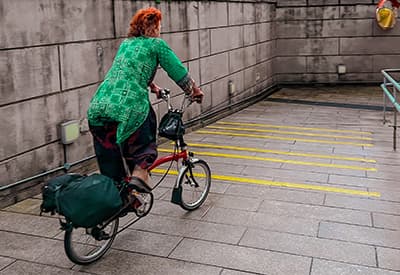 A person cycling down a ramp on an everyday journey